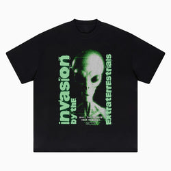 Black t-shirt with green alien graphic and text on a white background