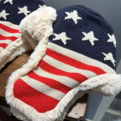 Knitted hat with American flag design on a wooden surface