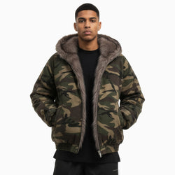 Person wearing a camouflage jacket with gray fur lining on a white background