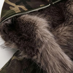 Close-up of a camouflage jacket with fur lining on a white background
