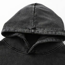 Close-up of a dark gray hood on a plain background