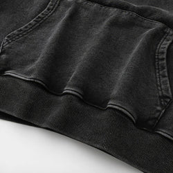Close-up of a black washed hoodie on a white background