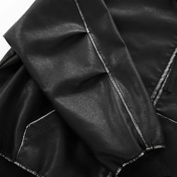 Close-up of black leather fabric with visible stitching