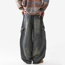 Person wearing wide-leg jeans and a plaid sweater on a white background