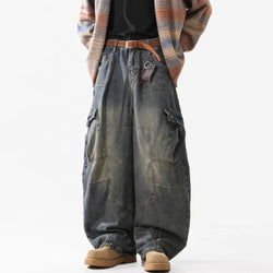 Person wearing wide-leg jeans and a plaid jacket on a white background