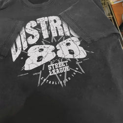 Black t-shirt with white graphic design on a dark background