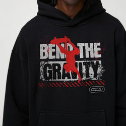 Person wearing a black hoodie with a graphic design and text on a white background