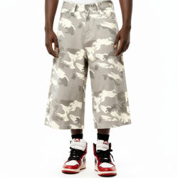 Camouflage pants worn by a person on a white background