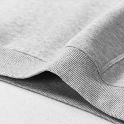 Close-up of gray fabric with a focus on texture and stitching.