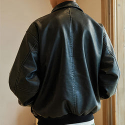 Black leather jacket worn by a person with a neutral background