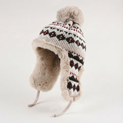Knitted hat with fur trim and pom-pom on a white background