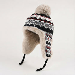 Knitted hat with fur trim on a white background