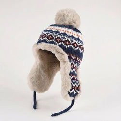 Knitted hat with fur trim and pom-pom on a white background