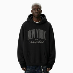 Person wearing a black hoodie with &